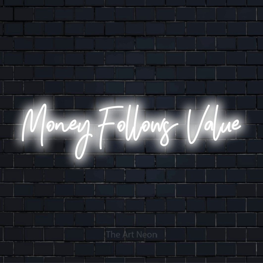 "Money Follows Value" text design with neon effect on a black brick wall