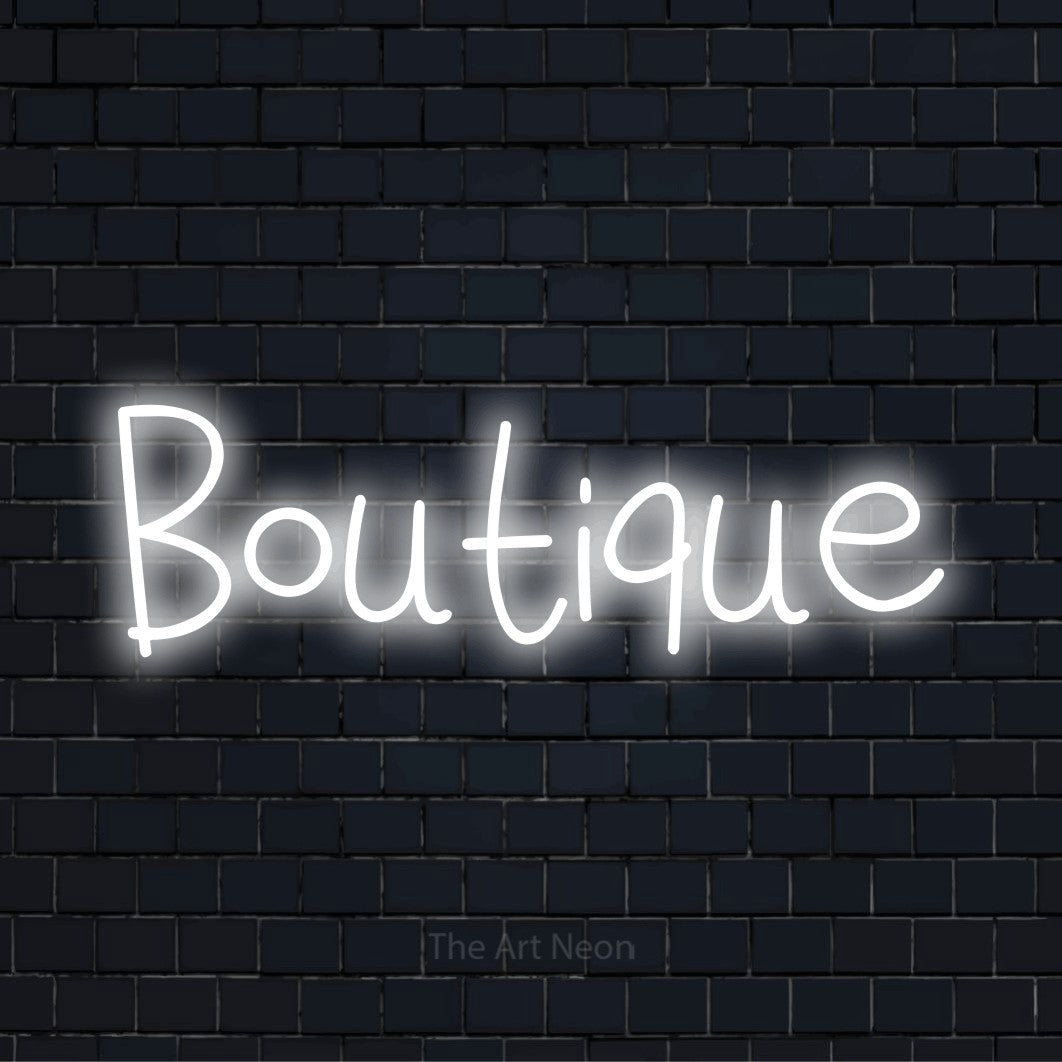LED-Neonschild mit dem Text „Boutique“ auf dunkler Ziegelwand