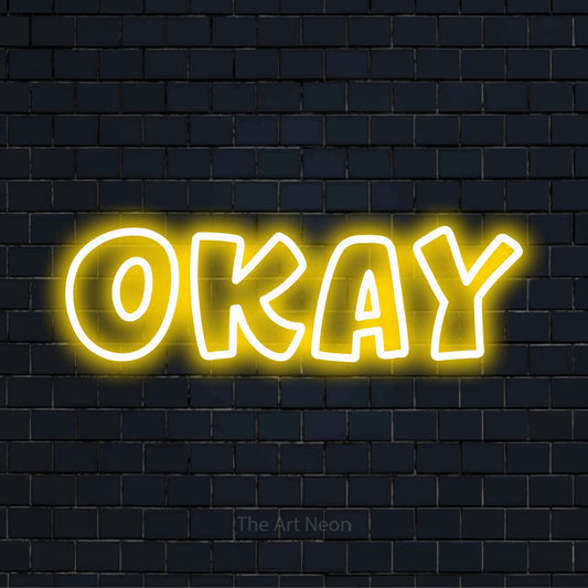 "Okay" glowing LED neon sign on a black brick wall