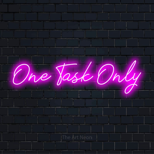 "One Task Only" script-style LED neon sign on a black brick wall