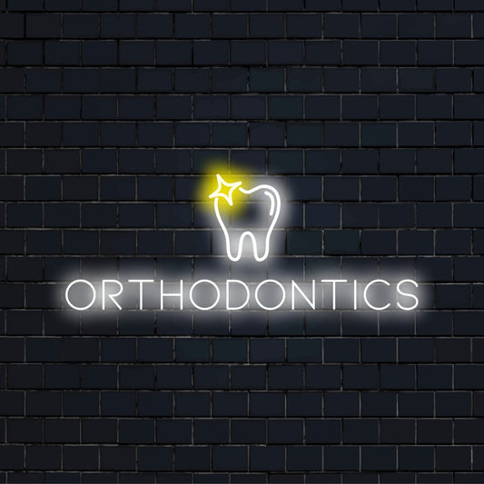 Orthodontics Neon Sign, glowing neon text against black brick wall