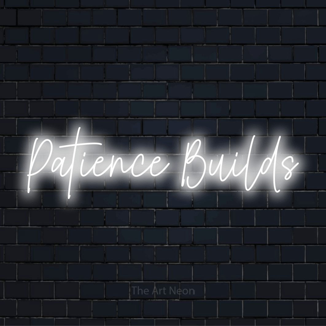 "Patience Builds" glowing LED neon sign on a black brick wall
