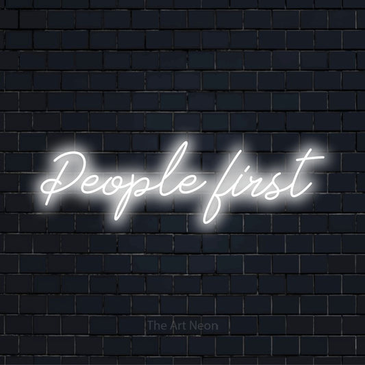"People First" text design with neon effect on a black brick wall