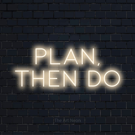 "Plan, Then Do" LED neon sign on a black brick wall