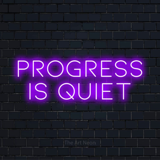 "Progress Is Quiet" text design with neon effect on a black brick wall