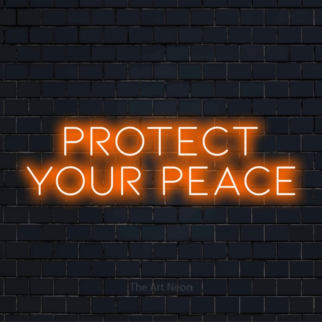 "Protect Your Peace" script-style LED neon sign on a black brick wall
