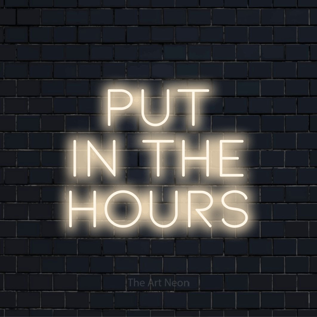 "Put In The Hours" text design with neon effect on a black brick wall
