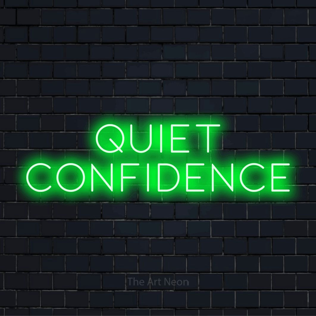 "Quiet Confidence" script-style LED neon sign on a black brick wall