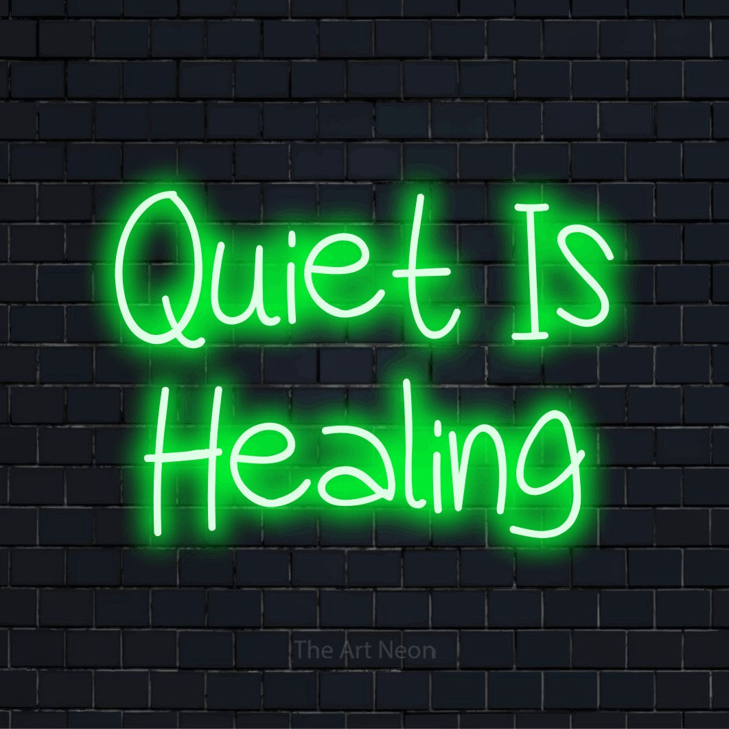 "Quiet Is Healing" LED neon sign on a black brick wall