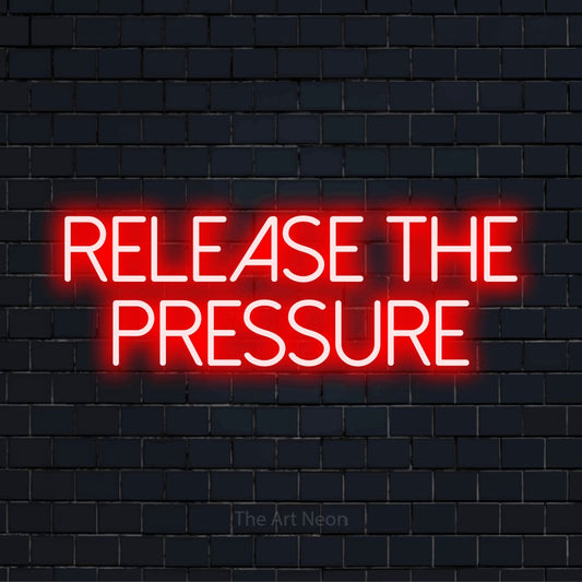 "Release The Pressure" glowing LED neon sign on a black brick wall