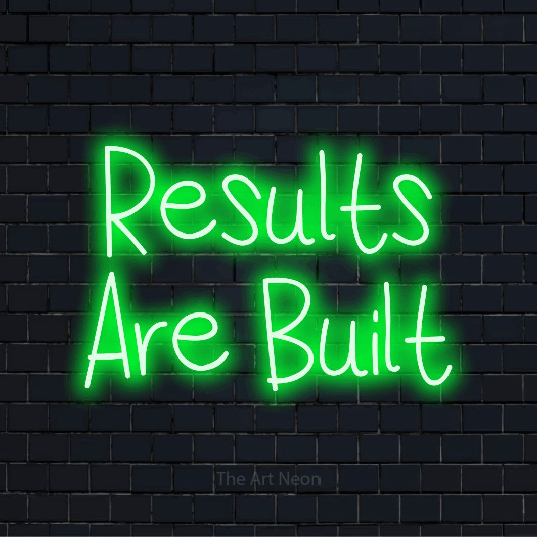 "Results Are Built" LED neon sign on a black brick wall
