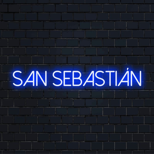 San Sebasti N Neon Sign, bright neon glow against black brick wall