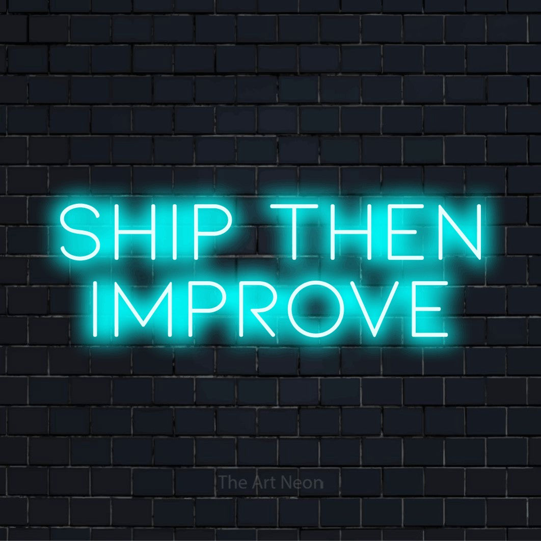 "Ship Then Improve" neon text design on a black brick wall