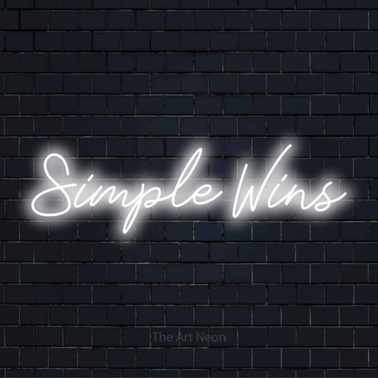 "Simple Wins" neon text design on a black brick wall