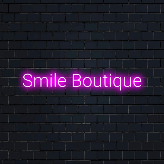 Smile Boutique Neon Light with glowing wall decor on dark brick background
