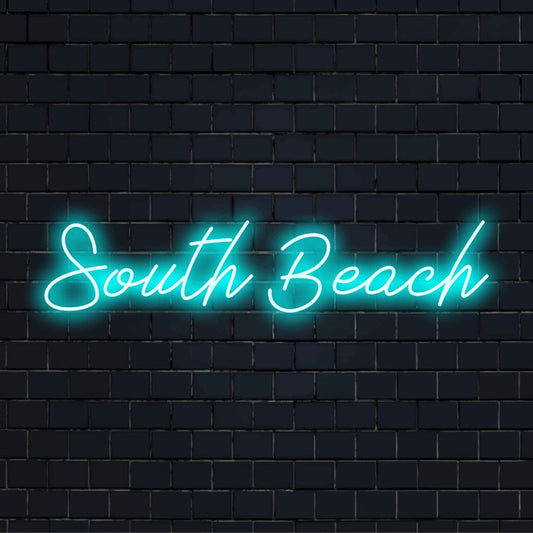 South Beach Neon Light with glowing neon text against black brick wall