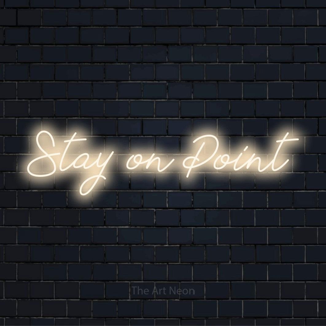 "Stay On Point" text design with neon effect on a black brick wall