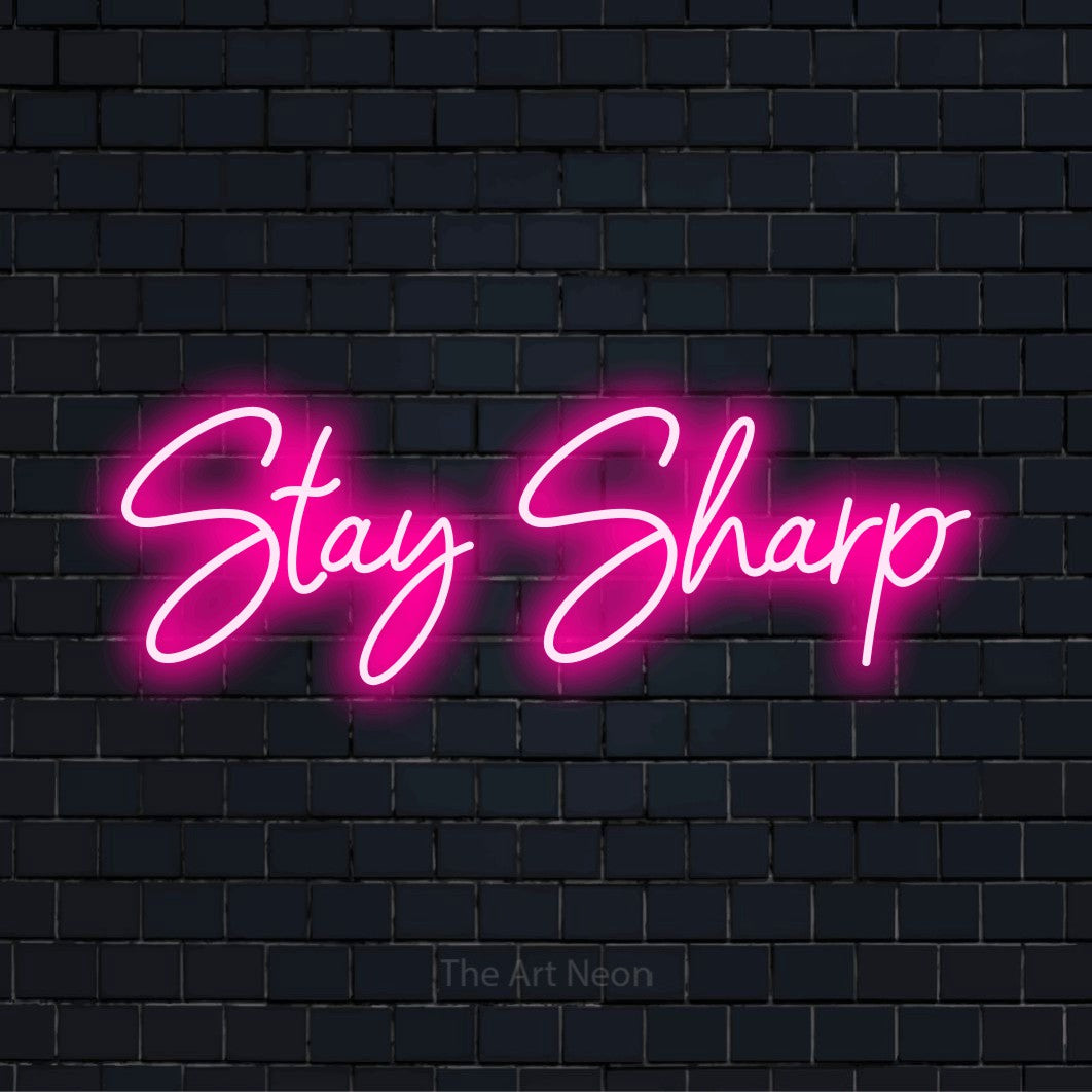 "Stay Sharp" text design with neon effect on a black brick wall