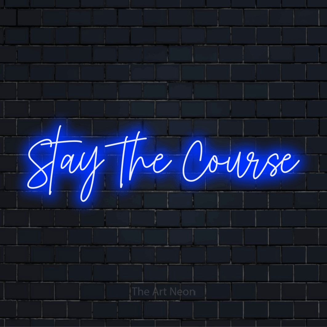 "Stay The Course" script-style LED neon sign on a black brick wall