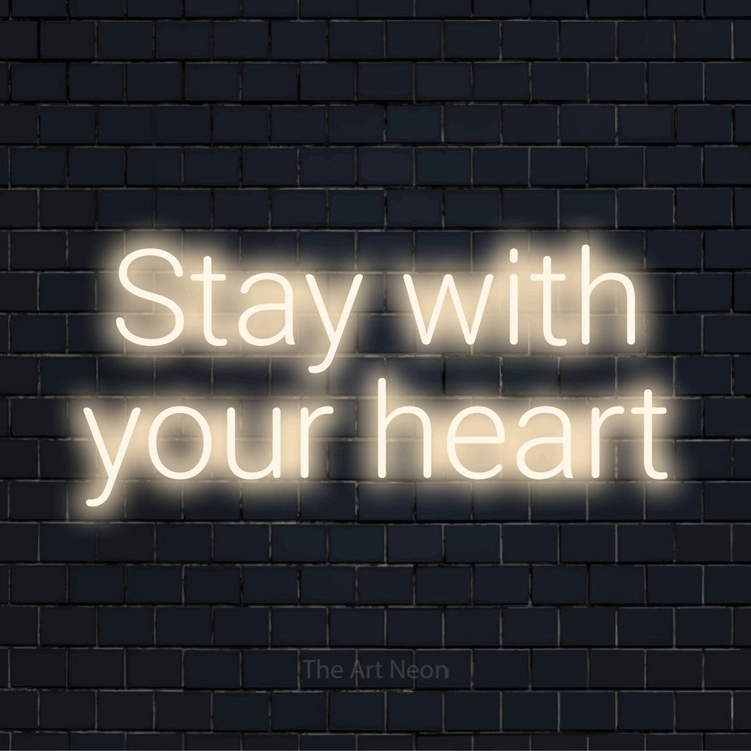 "Stay With Your Heart" text design with neon effect on a black brick wall