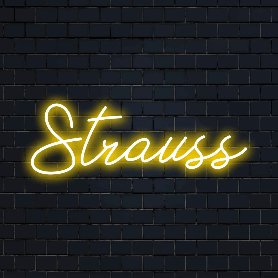 Strauss Neon Sign, bright neon lettering against black brick wall