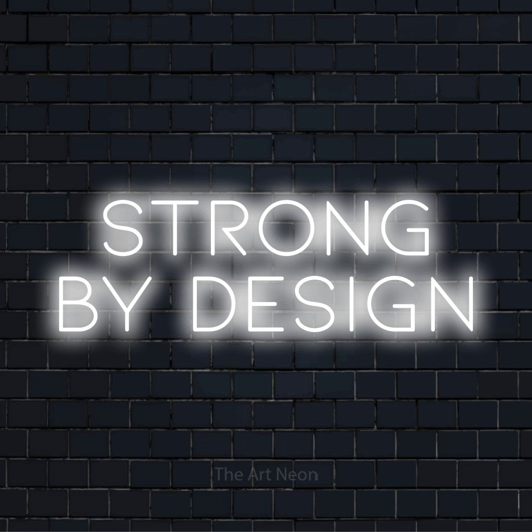 "Strong By Design" text design with neon effect on a black brick wall