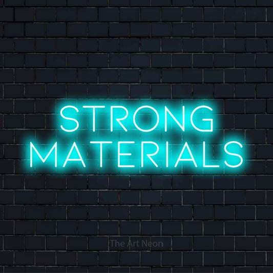 "Strong Materials" text design with neon effect on a black brick wall