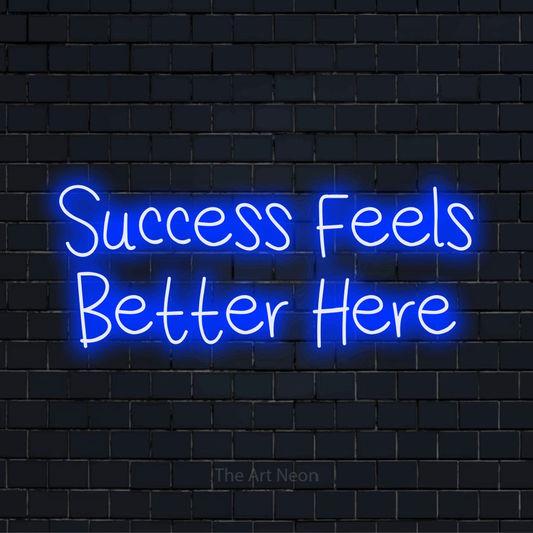 "Success Feels Better Here" neon text design on a black brick wall