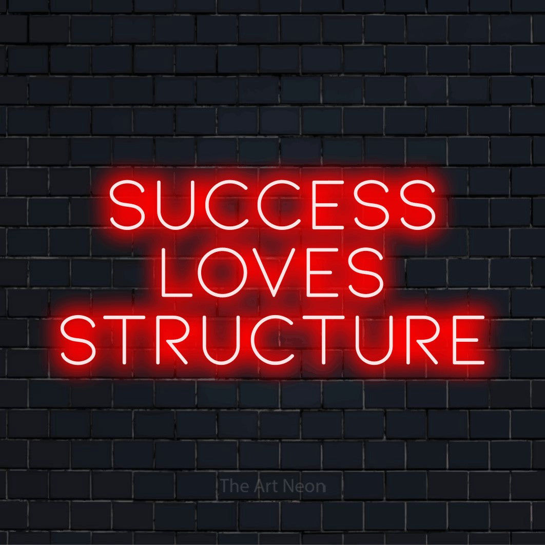 "Success Loves Structure" text design with neon effect on a black brick wall