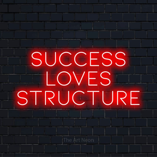 "Success Loves Structure" text design with neon effect on a black brick wall