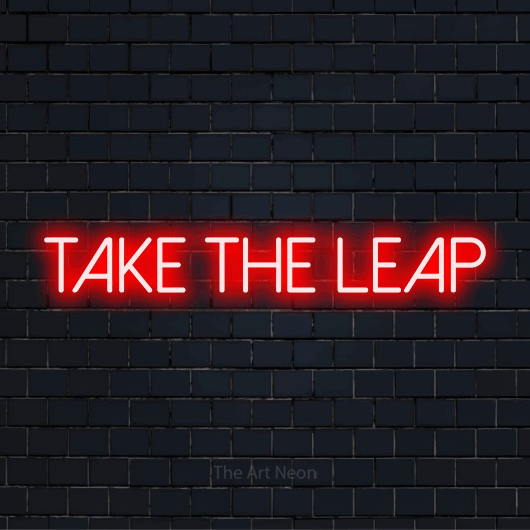 "Take The Leap" neon text design on a black brick wall