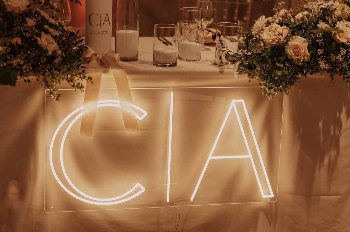 Warm white C&A wedding LED neon sign styled with flowers and candles