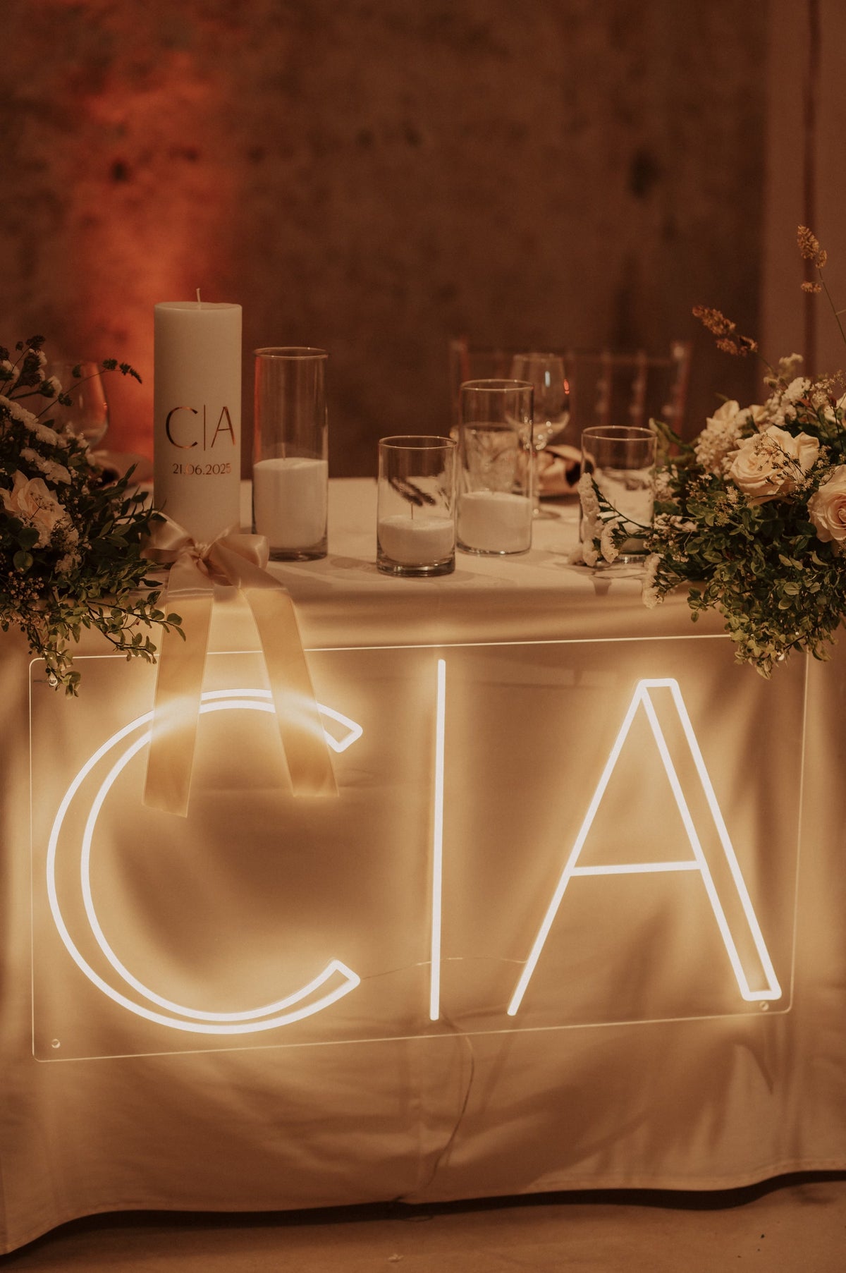 Warm-white C and A initials LED neon displayed on a table for a wedding celebration.