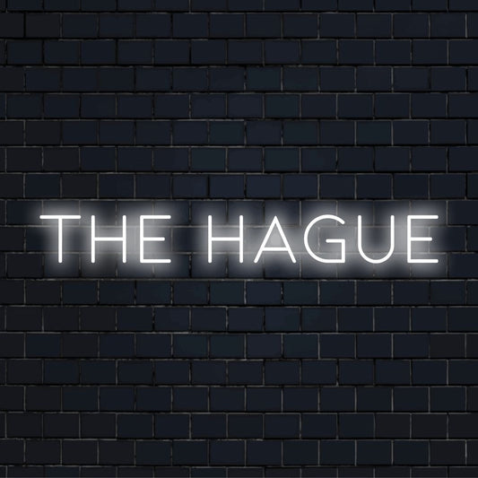 The Hague LED Neon Sign, bright neon lettering on dark brick background