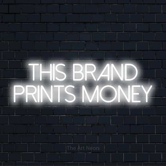 "This Brand Prints Money" glowing LED neon sign on a black brick wall