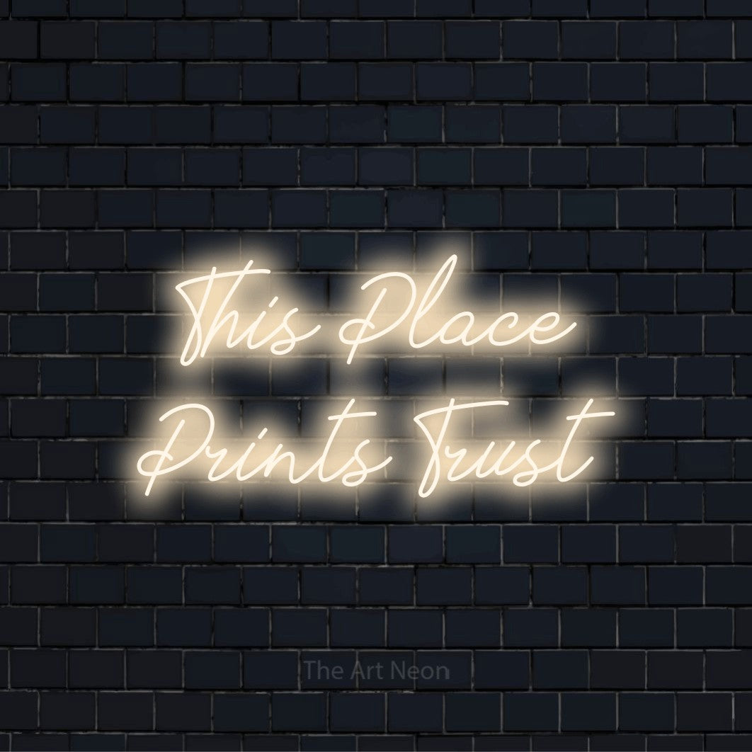 "This Place Prints Trust" script-style LED neon sign on a black brick wall