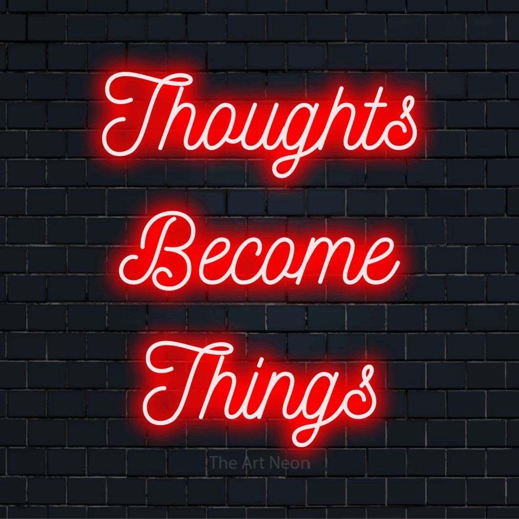 "Thoughts Become Things" LED neon sign on a black brick wall