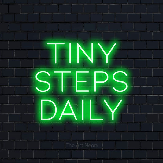 "Tiny Steps Daily" text design with neon effect on a black brick wall