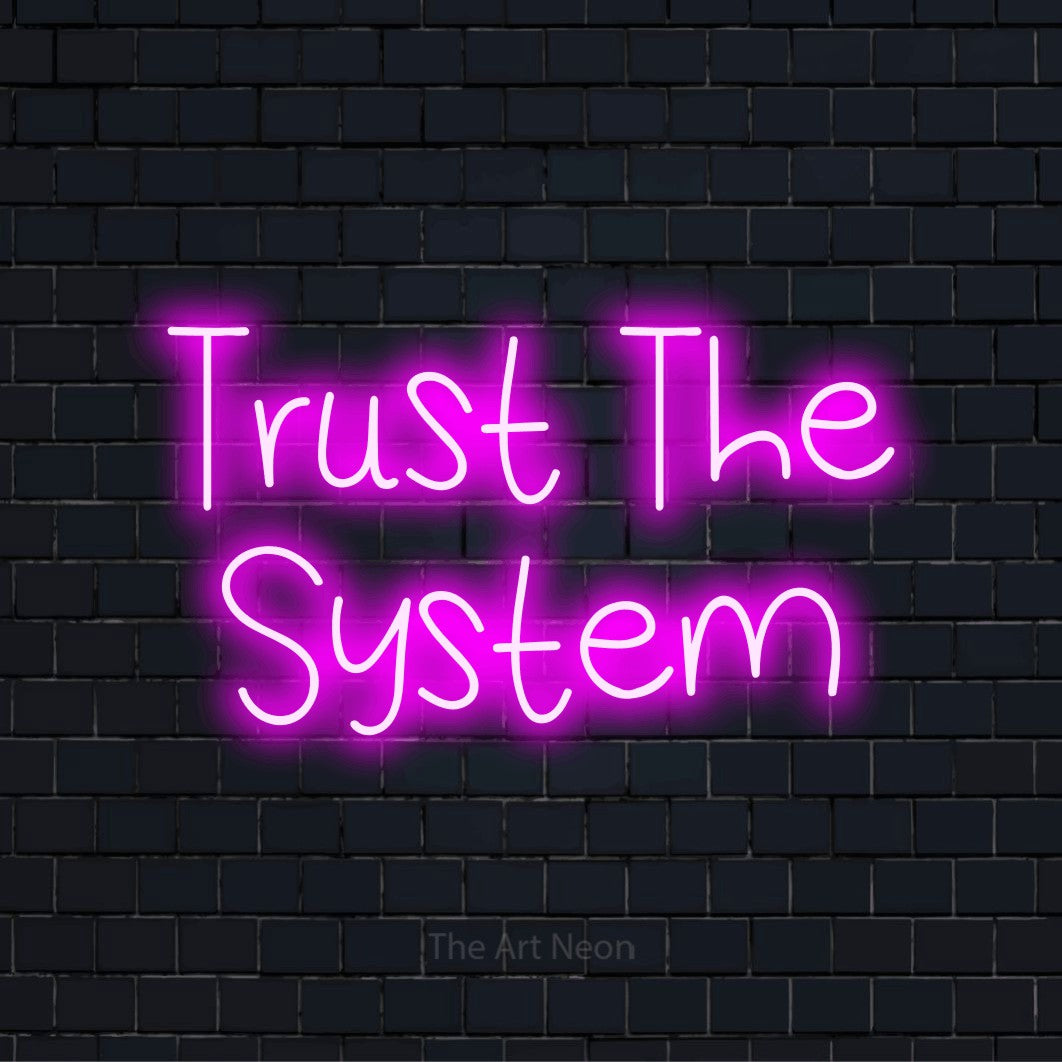 "Trust The System" script-style LED neon sign on a black brick wall