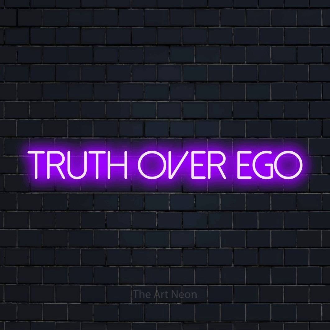 "Truth Over Ego" text design with neon effect on a black brick wall