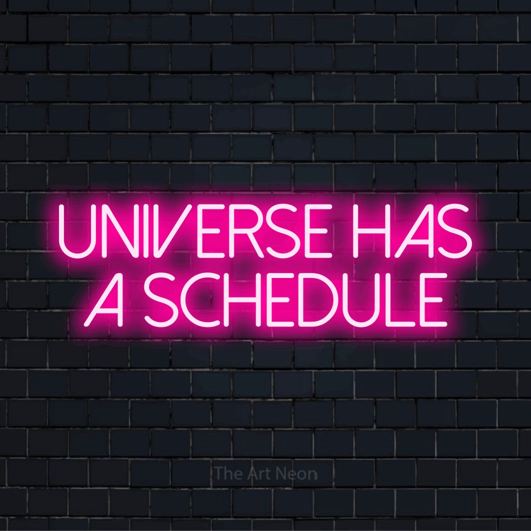 "Universe Has A Schedule" text design with neon effect on a black brick wall