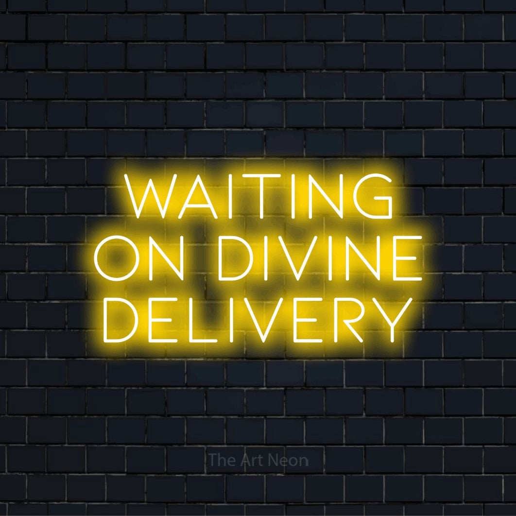 "Waiting On Divine Delivery" script-style LED neon sign on a black brick wall