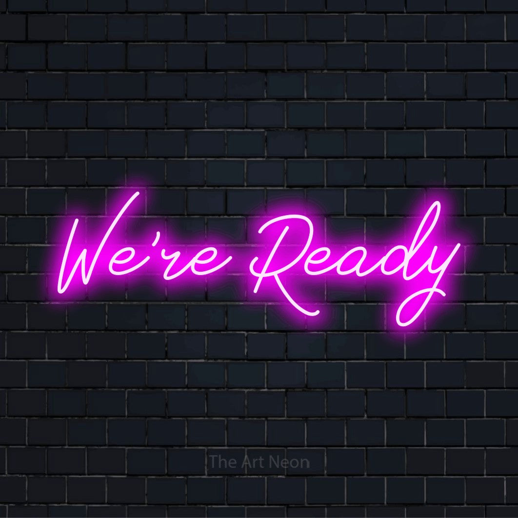 "We’re Ready" glowing LED neon sign on a black brick wall