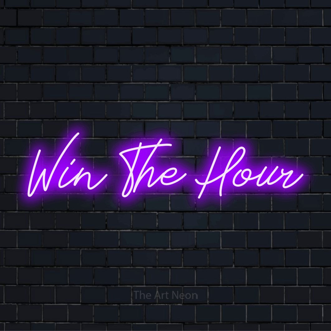 "Win The Hour" script-style LED neon sign on a black brick wall