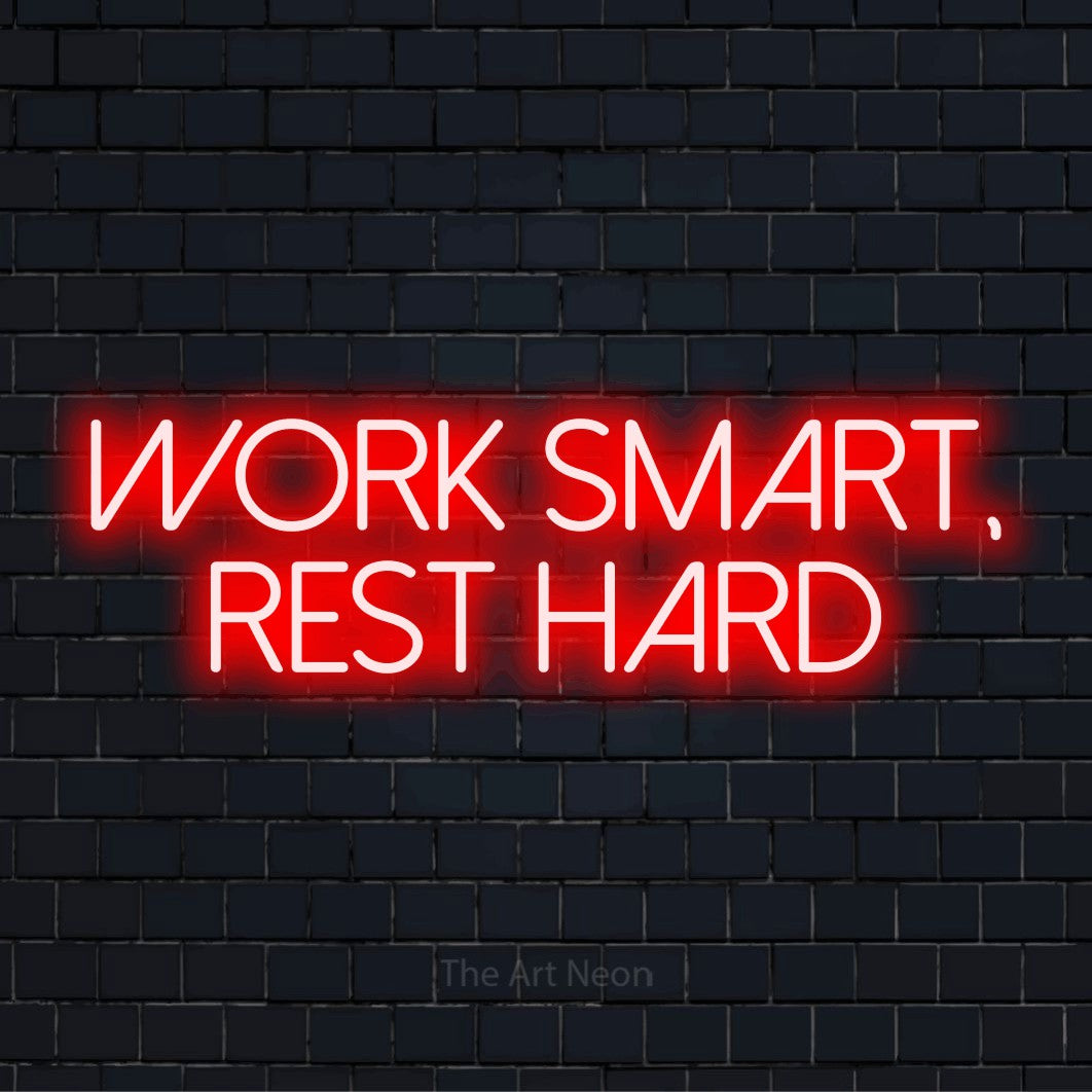 "Work Smart, Rest Hard" neon text design on a black brick wall