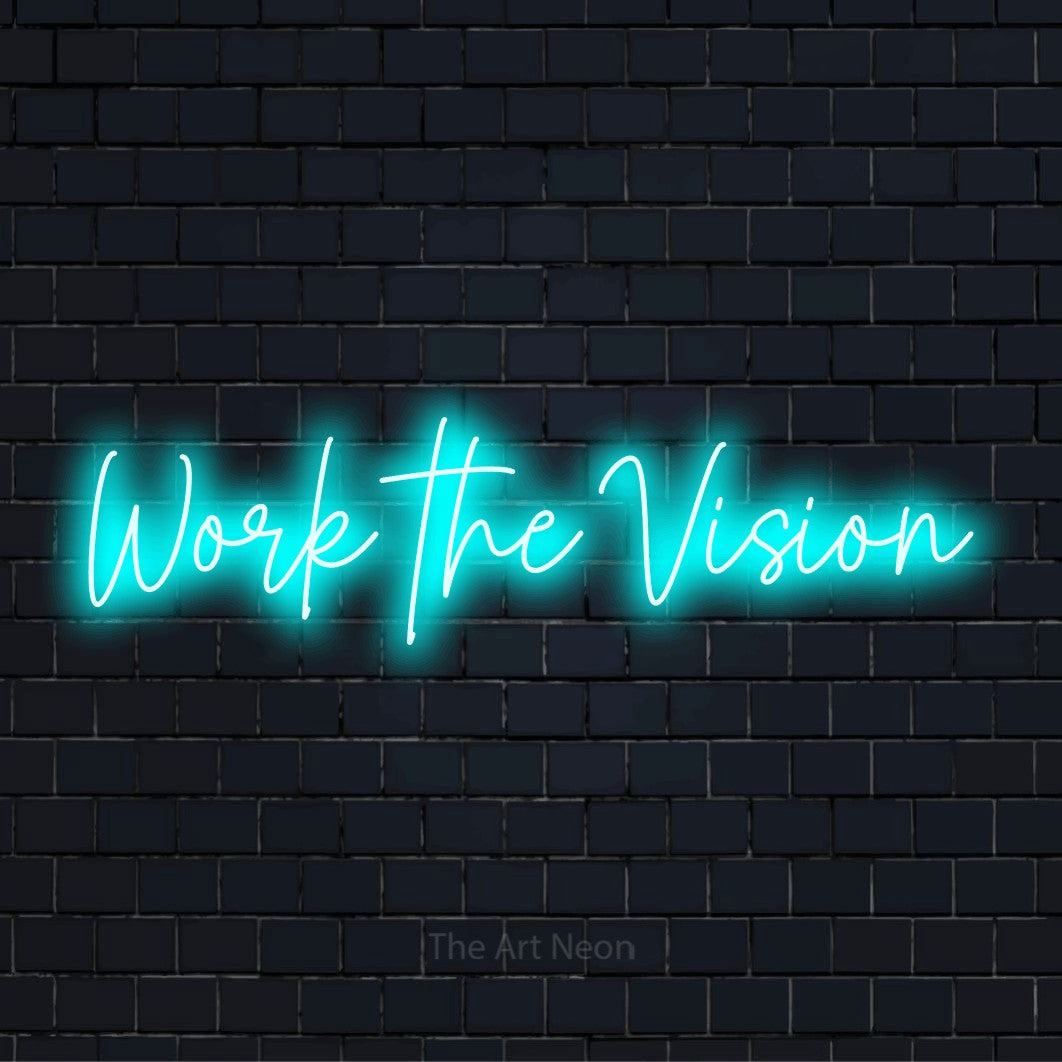"Work The Vision" script-style LED neon sign on a black brick wall