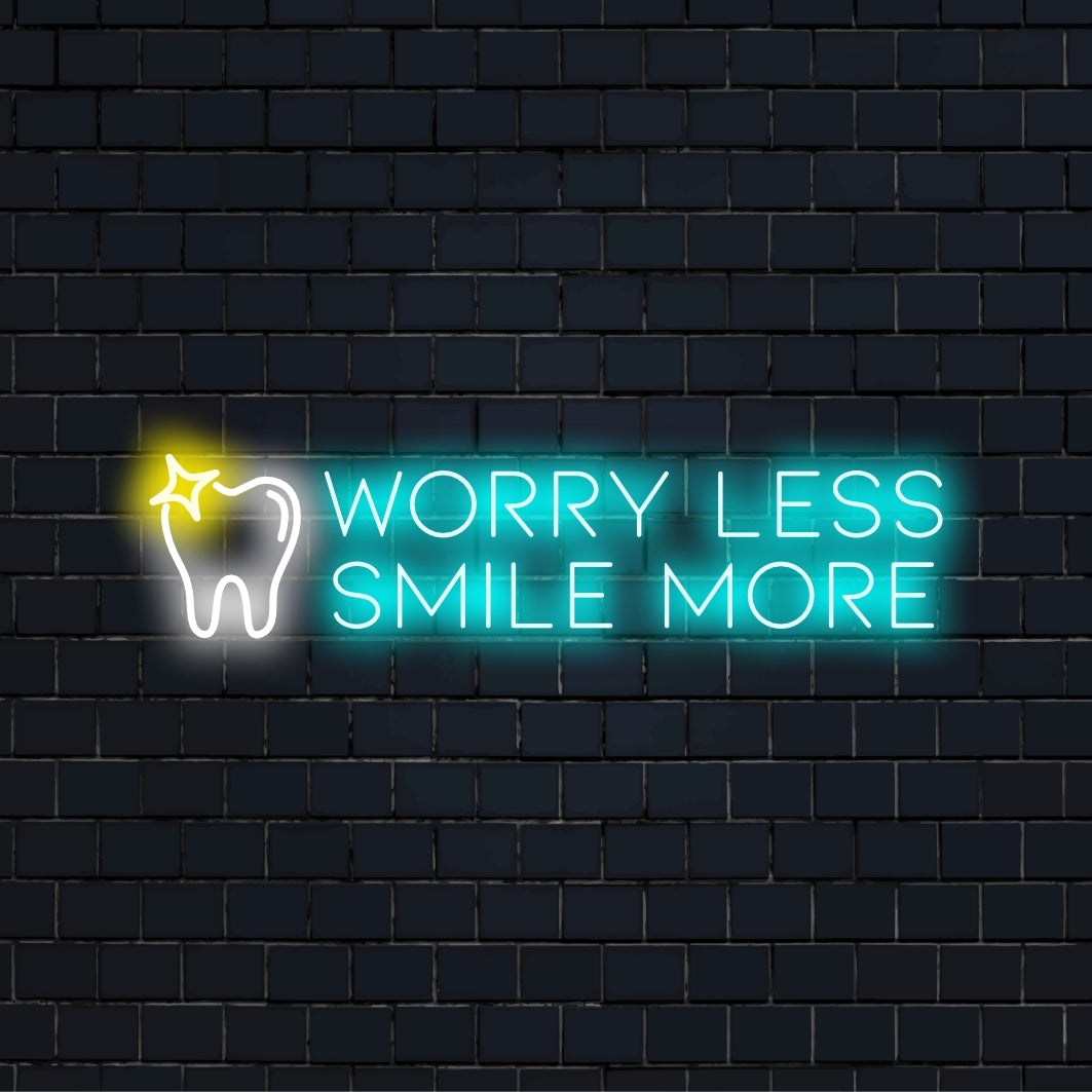 Worry Less Smile More LED Neon Sign, glowing lettering against black brick wall