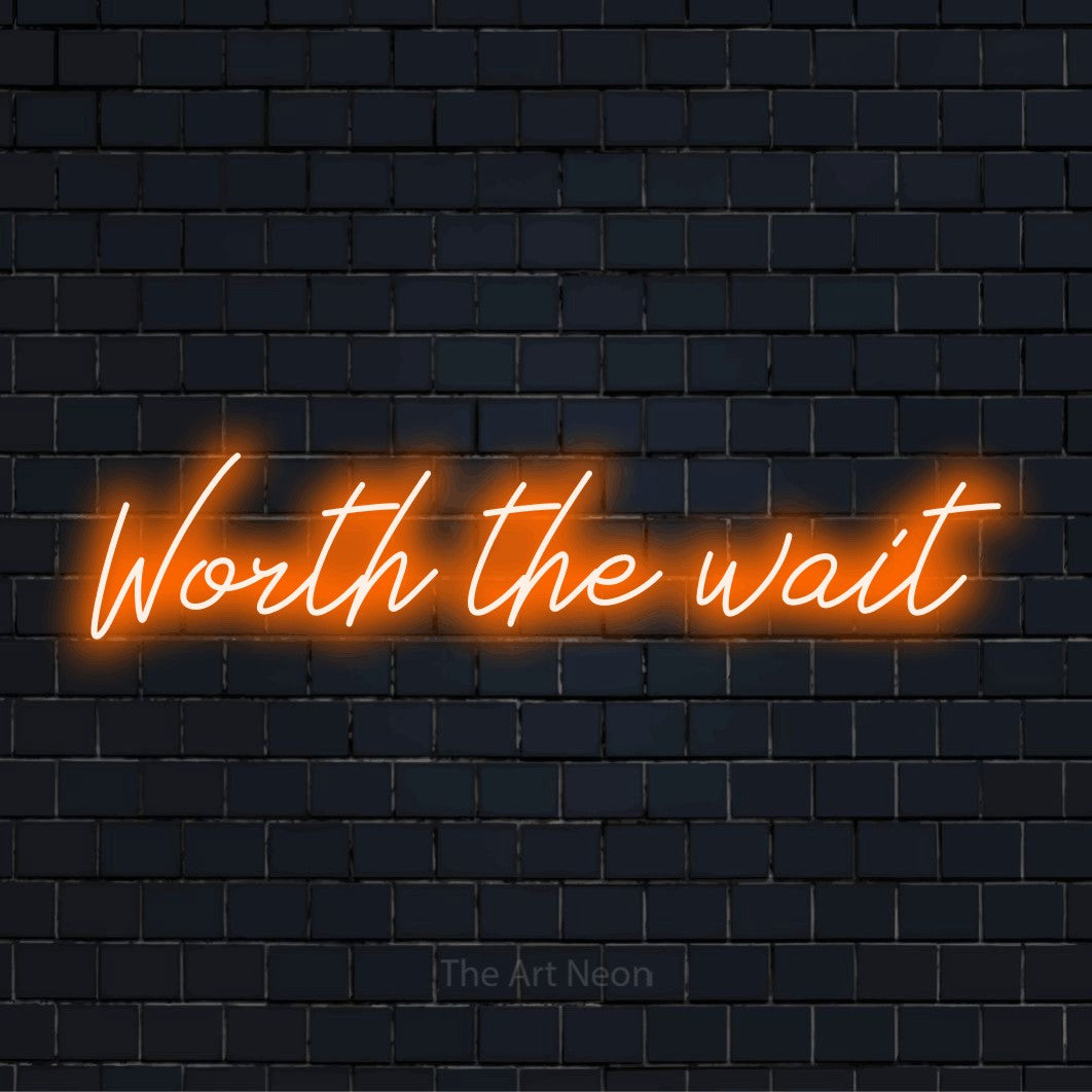 "Worth The Wait" glowing LED neon sign on a black brick wall